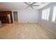 Spacious living room with neutral walls, tiled floors, shuttered windows and stainless steel refrigerator at 8084 Bosco Bay Ave, Las Vegas, NV 89113