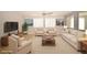 Staged living room with neutral walls, tiled floors, shuttered windows, white furniture, and plenty of natural light at 8084 Bosco Bay Ave, Las Vegas, NV 89113