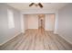 Open-concept living room featuring wood-look flooring and fresh paint at 8084 Bosco Bay Ave, Las Vegas, NV 89113