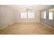 Spacious living room with neutral walls, tiled floors, and shuttered windows, providing a bright and airy atmosphere at 8084 Bosco Bay Ave, Las Vegas, NV 89113