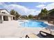 Community pool featuring clear blue water and comfortable lounge chairs for relaxing poolside at 8084 Bosco Bay Ave, Las Vegas, NV 89113