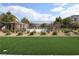 Inviting community pool area featuring a decorative fence and lush green turf at 8084 Bosco Bay Ave, Las Vegas, NV 89113
