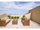 Comfortable outdoor seating with decorative plants on a rooftop patio at 8084 Bosco Bay Ave, Las Vegas, NV 89113