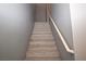 Staircase with hardwood steps and white railing, leading to the upper level of the house at 8084 Bosco Bay Ave, Las Vegas, NV 89113