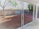 Covered patio space in backyard that features low-maintenance landscaping and a privacy wall at 8512 Manalang Rd, Las Vegas, NV 89123