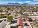 Aerial view of a neighborhood showcasing well-maintained homes, landscaping, and nearby mountains at 8552 Desert Holly Dr, Las Vegas, NV 89134