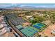 Extensive aerial view showcases community amenities, including tennis courts and a swimming pool at 8552 Desert Holly Dr, Las Vegas, NV 89134