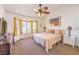 Comfortable bedroom featuring a ceiling fan, bay window, and cozy decor at 8552 Desert Holly Dr, Las Vegas, NV 89134