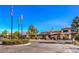 Elegant clubhouse entrance featuring manicured landscaping and clear blue skies at 8552 Desert Holly Dr, Las Vegas, NV 89134