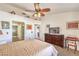 Comfortable main bedroom featuring a ceiling fan, TV atop a dresser, and ensuite access at 8552 Desert Holly Dr, Las Vegas, NV 89134