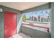 Charming balcony with a vibrant red door, offering scenic views of the neighborhood and covered parking at 8600 W Charleston Blvd # 2098, Las Vegas, NV 89117