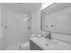 Modern bathroom featuring a glass shower, white marble-look tile, contemporary fixtures and a large mirror at 8600 W Charleston Blvd # 2098, Las Vegas, NV 89117