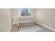 Bright bedroom with wood floors, large window, and a comfortable loveseat for relaxing at 8600 W Charleston Blvd # 2098, Las Vegas, NV 89117