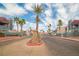 Welcoming community entrance featuring a gate and beautifully landscaped surroundings with mature palm trees at 8600 W Charleston Blvd # 2098, Las Vegas, NV 89117