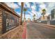 Elegant community entrance with a prominent sign amidst lush palm trees and well-maintained landscaping at 8600 W Charleston Blvd # 2098, Las Vegas, NV 89117