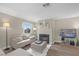 Inviting living room with neutral tones, a cozy fireplace, wood floors and a large window for natural light at 8600 W Charleston Blvd # 2098, Las Vegas, NV 89117