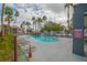 Relaxing community pool area surrounded by swaying palm trees, cozy seating, and a soothing spa at 8600 W Charleston Blvd # 2098, Las Vegas, NV 89117