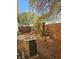 Backyard features desert landscaping, trees, an AC unit, and rock border at 8993 Secret Valley St, Las Vegas, NV 89139