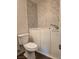 Bathroom featuring toilet and luxurious walk-in tub with marble-look surround at 8993 Secret Valley St, Las Vegas, NV 89139