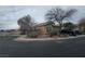 A well kept home with desert landscaping, a driveway for parking, and mature shade trees at 8993 Secret Valley St, Las Vegas, NV 89139
