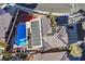 Aerial view of the home featuring solar panels, a sparkling pool, and a well-maintained backyard at 9225 Evergreen Canyon Dr, Las Vegas, NV 89134