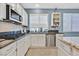 A kitchen featuring granite countertops, stainless steel appliances, and white cabinets at 9225 Evergreen Canyon Dr, Las Vegas, NV 89134