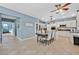 Bright kitchen with white cabinets, stainless steel appliances, island and eat in dining area at 9225 Evergreen Canyon Dr, Las Vegas, NV 89134