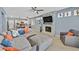 A spacious living room with a gray sectional sofa, and a fireplace with a stone surround at 9225 Evergreen Canyon Dr, Las Vegas, NV 89134