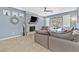 Comfortable living room with a stone fireplace, plush sofa, and sliding glass doors to the patio at 9225 Evergreen Canyon Dr, Las Vegas, NV 89134