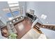 A high angle view of a living room with wood flooring, an sectional sofa, and bright lighting at 9225 Evergreen Canyon Dr, Las Vegas, NV 89134