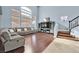 Bright living room with hardwood floors, a large window, and a comfortable sectional sofa at 9225 Evergreen Canyon Dr, Las Vegas, NV 89134