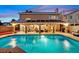 Inviting backyard oasis with a covered patio, ample seating, and a refreshing swimming pool at 9225 Evergreen Canyon Dr, Las Vegas, NV 89134