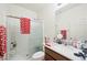 A bathroom with a vanity, a mirror, a toilet, and a walk-in shower with heart-themed red and white towels at 984 Brilliant Meadow Ave, North Las Vegas, NV 89086