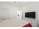 A bedroom with a ceiling fan, a closet, an open doorway into the hallway, and a white dresser with a TV at 984 Brilliant Meadow Ave, North Las Vegas, NV 89086