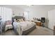 Spacious bedroom with plush carpet, a stylish upholstered bed and bright natural light at 984 Brilliant Meadow Ave, North Las Vegas, NV 89086
