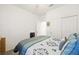 This bedroom showcases a well-made bed, an open doorway, a ceiling fan, and a built-in closet at 984 Brilliant Meadow Ave, North Las Vegas, NV 89086