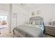 This bedroom features a well-made bed, a ceiling fan, a closet, and a view into the dining room at 984 Brilliant Meadow Ave, North Las Vegas, NV 89086