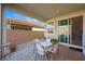 Cozy covered patio with brick pavers and comfortable seating area, perfect for outdoor relaxation at 984 Brilliant Meadow Ave, North Las Vegas, NV 89086