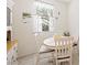 Bright dining nook with white table, chairs, and sunny window at 984 Brilliant Meadow Ave, North Las Vegas, NV 89086