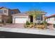 Charming single-story home featuring a paver driveway, two-car garage, and desert landscaping at 984 Brilliant Meadow Ave, North Las Vegas, NV 89086
