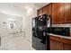 The kitchen features dark wood cabinets, tiled flooring, and stainless steel refrigerator at 984 Brilliant Meadow Ave, North Las Vegas, NV 89086