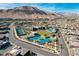Wide aerial view of community featuring community center with a pool, tennis courts, and surrounding single-Gathering homes at 10001 Regency Square Ave, Las Vegas, NV 89148