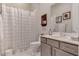 Bright bathroom showcasing a toilet, vanity with neutral cabinetry, and a shower with a patterned curtain at 10001 Regency Square Ave, Las Vegas, NV 89148