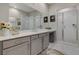 Bathroom with double vanity, quartz counters, and glass-enclosed shower at 10001 Regency Square Ave, Las Vegas, NV 89148