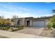 Charming single-story home with brick-paved driveway, desert landscaping and gray two-car garage under a clear blue sky at 10001 Regency Square Ave, Las Vegas, NV 89148