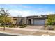 A modern single-story house featuring drought-resistant landscaping and a large brick driveway with a two-car garage at 10001 Regency Square Ave, Las Vegas, NV 89148
