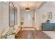 Bright foyer with wood floors, accent wall with mirrors and a view of the entryway and living area at 10001 Regency Square Ave, Las Vegas, NV 89148