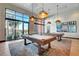 Game room featuring pool tables, large windows, and stylish lighting fixtures at 10001 Regency Square Ave, Las Vegas, NV 89148