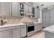 Chef's kitchen featuring custom backsplash and stainless steel oven at 10001 Regency Square Ave, Las Vegas, NV 89148
