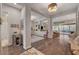 A bright and open living room with wood floors, an ornate decorative cabinet and view to the backyard at 10001 Regency Square Ave, Las Vegas, NV 89148